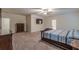 Open Primary bedroom featuring plush carpet, mounted TV, and doorway to on-suite bath at 9061 Jim Purcell Dr, Covington, GA 30014