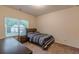 Bedroom with carpeted floors and a single window next to a full-sized bed and nightstand at 9061 Jim Purcell Dr, Covington, GA 30014