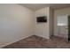 This bedroom features neutral walls, carpet floors and a mounted television at 9061 Jim Purcell Dr, Covington, GA 30014