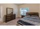 Bedroom featuring a dark wood dresser, nightstand, and a full-sized bed with carpeted floors at 9061 Jim Purcell Dr, Covington, GA 30014