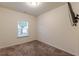 Neutral bedroom featuring carpet floors, natural light, and a ceiling light fixture at 9061 Jim Purcell Dr, Covington, GA 30014