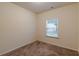 This bedroom has carpet floors, neutral walls and a window at 9061 Jim Purcell Dr, Covington, GA 30014