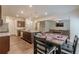 Open-concept dining area features modern pendant lighting, kitchen island, and seamless flow to the living room at 9061 Jim Purcell Dr, Covington, GA 30014