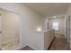 Upstairs hallway with carpeted floors and white walls, with tile flooring near doorways at 9061 Jim Purcell Dr, Covington, GA 30014