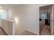 Upstairs hallway with carpeted floors and white walls leads to a bedroom with dark wood furniture at 9061 Jim Purcell Dr, Covington, GA 30014