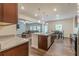 Kitchen featuring granite countertops, stainless appliances, wood cabinets, island, and open floorplan at 9061 Jim Purcell Dr, Covington, GA 30014