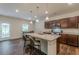 Kitchen featuring granite countertops, stainless appliances, wood cabinets, and island with bar seating at 9061 Jim Purcell Dr, Covington, GA 30014