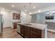 Spacious kitchen island featuring granite countertops, stainless sink, and wood cabinets, offering an open floorplan at 9061 Jim Purcell Dr, Covington, GA 30014