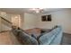 Living room with sectional sofa, large windows, and a staircase with modern railing at 9061 Jim Purcell Dr, Covington, GA 30014