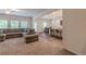 Open-concept living room with plush carpeting, large sectional sofa, and seamless flow to the kitchen and dining area at 9061 Jim Purcell Dr, Covington, GA 30014