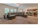 Open-concept living room with a large sectional sofa and easy access to the modern kitchen and dining area at 9061 Jim Purcell Dr, Covington, GA 30014