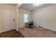 A cozy office featuring a window and neutral colored walls and carpet at 9061 Jim Purcell Dr, Covington, GA 30014