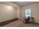 A light-filled home office with luxury vinyl plank flooring and a large window at 9061 Jim Purcell Dr, Covington, GA 30014