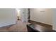The multi-purpose room features neutral carpet and is accessed from the main entry hallway at 9061 Jim Purcell Dr, Covington, GA 30014