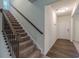 Carpeted stairs with decorative metal railings lead to the home's upper level at 9061 Jim Purcell Dr, Covington, GA 30014