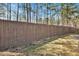 View of the home's backyard with a wood privacy fence and plenty of green space at 1080 Treymont Ln, Lawrenceville, GA 30045