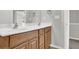 Bathroom featuring a dual sink vanity with wood cabinetry and modern faucets at 1080 Treymont Ln, Lawrenceville, GA 30045