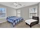 Bedroom with ample natural light, ceiling fan, large bed with blue and white comforter at 1080 Treymont Ln, Lawrenceville, GA 30045