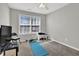 Bedroom includes a window, carpeted flooring, and space for exercise equipment at 1080 Treymont Ln, Lawrenceville, GA 30045