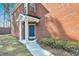Charming front entryway with a blue door, white columns, and well manicured shrubs at 1080 Treymont Ln, Lawrenceville, GA 30045