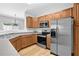 Well-equipped kitchen with stainless steel appliances, wood cabinets, and ample counter space at 1080 Treymont Ln, Lawrenceville, GA 30045