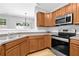 Well-lit kitchen featuring stainless steel appliances, wood cabinets, and laminate countertops at 1080 Treymont Ln, Lawrenceville, GA 30045