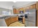 Functional kitchen featuring stainless steel appliances, ample cabinet space, and a sink with a window view at 1080 Treymont Ln, Lawrenceville, GA 30045
