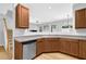 Modern kitchen featuring wood cabinets, a stainless steel dishwasher, and an open layout at 1080 Treymont Ln, Lawrenceville, GA 30045