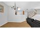 Bright, open-concept living space with hardwood floors, a chandelier, and a view of the staircase at 1080 Treymont Ln, Lawrenceville, GA 30045