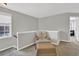 A loft space features a chair, footstool, and access to two doorways at 1080 Treymont Ln, Lawrenceville, GA 30045