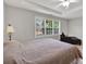 Spacious main bedroom featuring a ceiling fan, large windows and an ensuite seating area at 1080 Treymont Ln, Lawrenceville, GA 30045