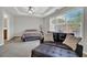 Spacious main bedroom featuring a ceiling fan, large windows and an ensuite seating area at 1080 Treymont Ln, Lawrenceville, GA 30045