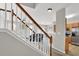 View of the staircase leading down to the living room and into the kitchen with stainless steel appliances at 1080 Treymont Ln, Lawrenceville, GA 30045