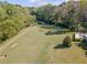 An aerial view of a vast, green landscape complemented by a serene pool area at 458 Valley Woods Se Cir, Conyers, GA 30094