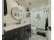 Bathroom featuring a modern vanity, a round mirror, and a tiled walk-in shower at 458 Valley Woods Se Cir, Conyers, GA 30094