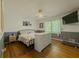 Bedroom with hardwood floors, stylish wall decor, ceiling fan, and natural light from the window at 458 Valley Woods Se Cir, Conyers, GA 30094