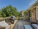 Wooden deck with grill and outdoor furniture overlooking yard at 458 Valley Woods Se Cir, Conyers, GA 30094