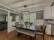 Dining area featuring hardwood floors, a dining table with upholstered chairs and bench seating at 458 Valley Woods Se Cir, Conyers, GA 30094