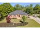 A beautiful brick house with a large manicured front lawn with mature trees and a long driveway at 458 Valley Woods Se Cir, Conyers, GA 30094
