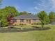 Charming brick home with a manicured lawn and beautifully landscaped garden beds at 458 Valley Woods Se Cir, Conyers, GA 30094