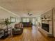 Spacious living room with hardwood floors, brick fireplace, and a comfortable seating area at 458 Valley Woods Se Cir, Conyers, GA 30094