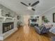 Bright living room featuring hardwood floors, brick fireplace, and a relaxing recliner at 458 Valley Woods Se Cir, Conyers, GA 30094
