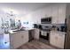 Bright kitchen features white cabinetry, stainless appliances, and hard wood flooring at 525 Parkway Ne Dr # 103, Atlanta, GA 30308