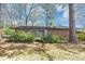 Backyard features a deck and lawn with mature trees and bushes at 5415 Orly Ter, Atlanta, GA 30349