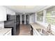 Charming kitchen featuring granite counters, black appliances, and vinyl plank flooring at 5415 Orly Ter, Atlanta, GA 30349