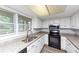 Bright kitchen with white cabinets, granite countertops, and stainless steel appliances at 5415 Orly Ter, Atlanta, GA 30349