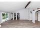Open living space with an adjacent kitchen, slider to the outside and an arched doorway at 5415 Orly Ter, Atlanta, GA 30349