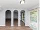 Bright living room featuring arched doorways and access to an outdoor deck at 5415 Orly Ter, Atlanta, GA 30349