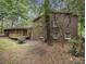View of the brick home exterior with a wood deck and green trees at 2544 Peyton Woods Sw Trl, Atlanta, GA 30311