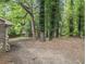 Spacious backyard featuring a wooded area and large trees for privacy and shade at 2544 Peyton Woods Sw Trl, Atlanta, GA 30311